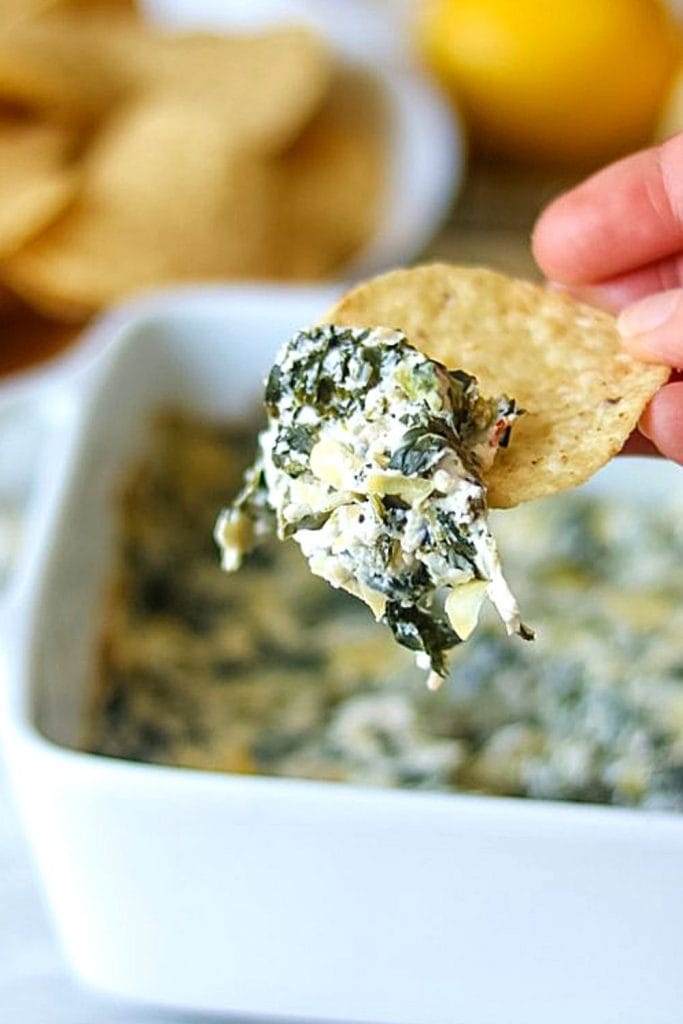 Spinach Artichoke Dip made being served with tortilla chips
