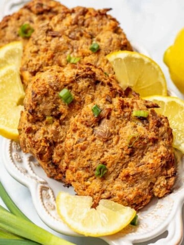 Easy Baked Tuna Patties plated on white plate with lemon wedges