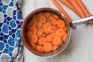 Pan with carrots slices covered with water