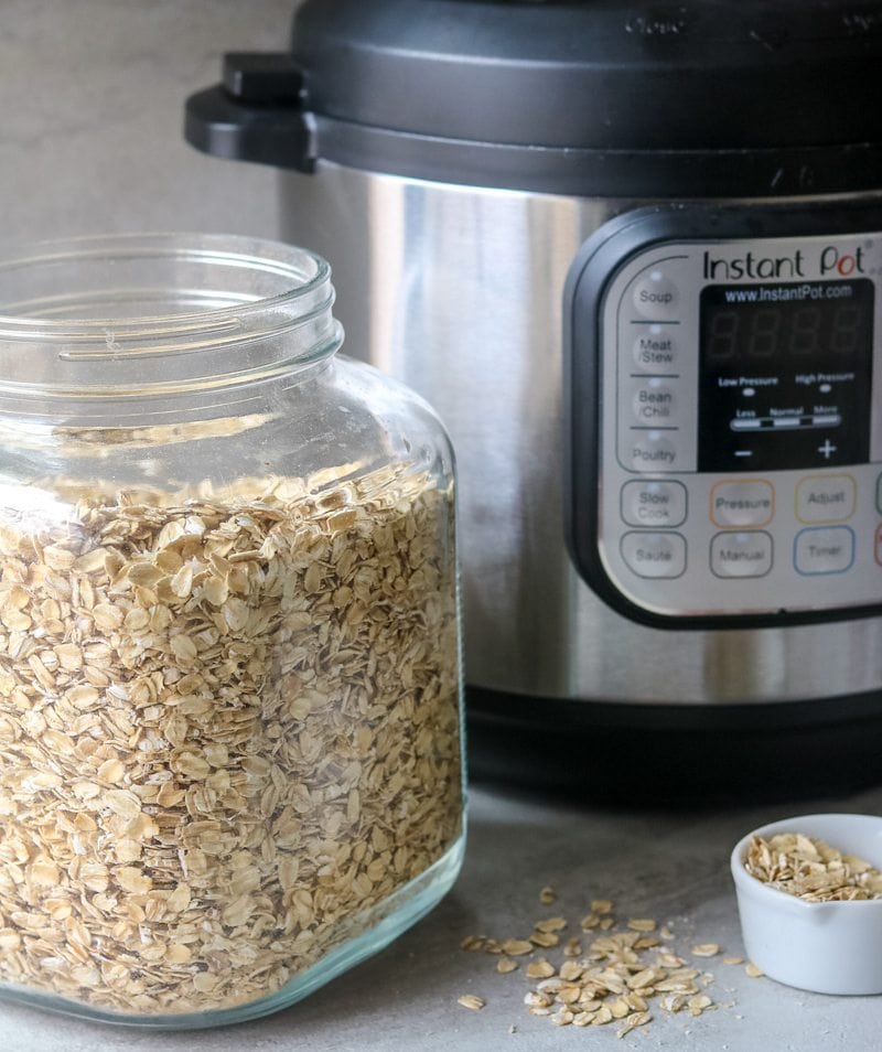 Instant Pot sitting next to clear container filled with old fashioned oats