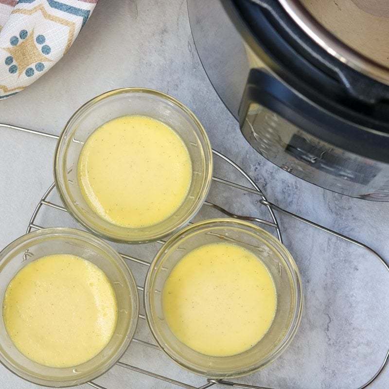 3 custard cups on trivet cooling after baking in instant pot
