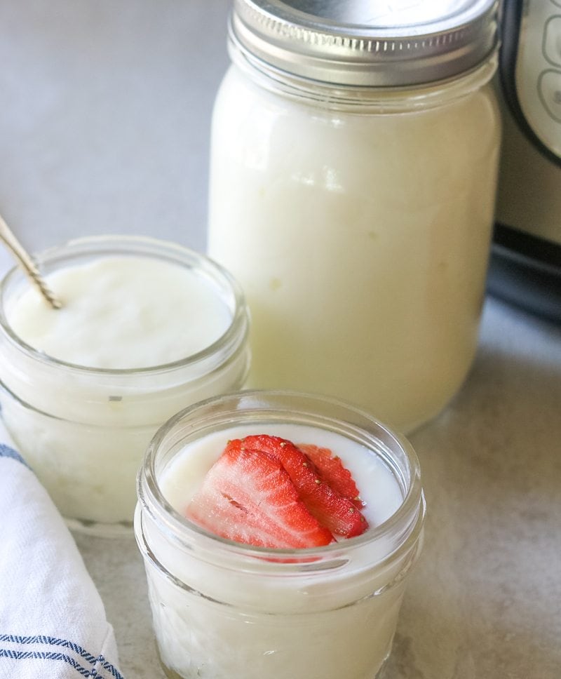 Instant Pot in background with 3 jars of homeamde yogurt