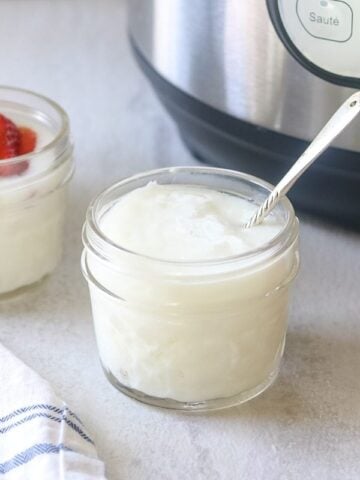 jar of plain yogurt next to instant pot