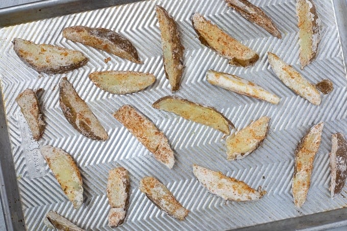 Seasoned Potato Wedges on cooking sheet