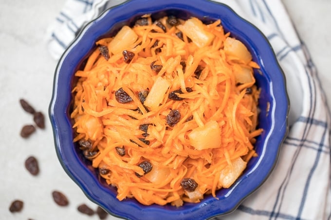 Carrot and Raisin Salad in Blue Bowl.