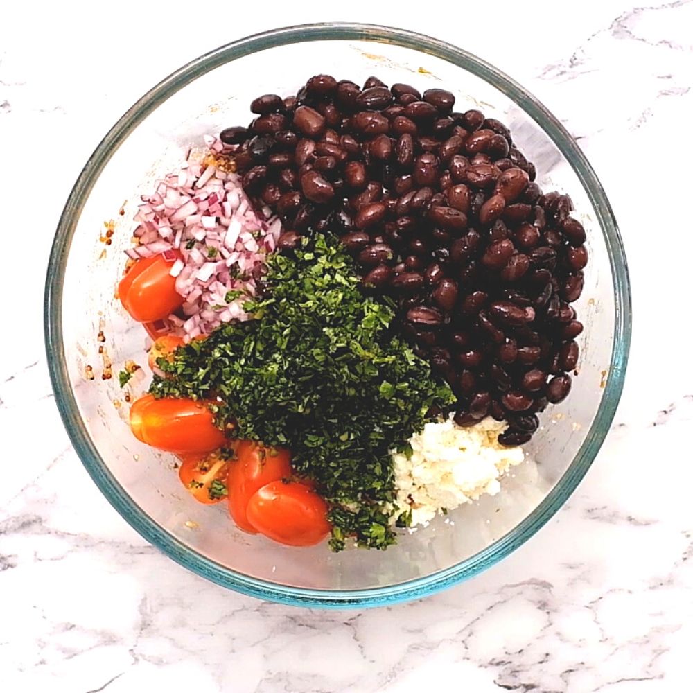 Ingredients for quinoa salad in mixing bowl