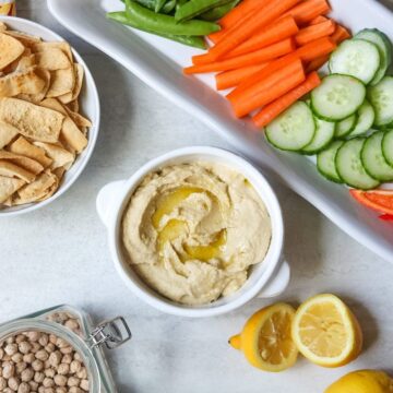 Hummus with fresh lemons and dried chickpeas on the side