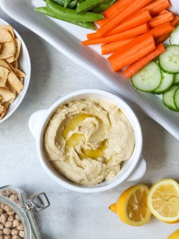 Hummus with fresh lemons and dried chickpeas on the side