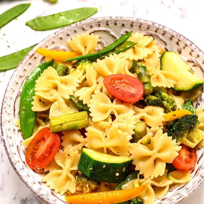 Bowl of Pasta with Vegetables topped with parmesan. 