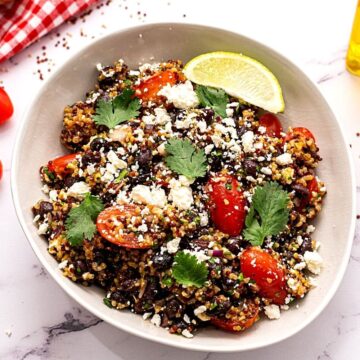 Quinoa Mexican Salad with Feta, Beans and Tomatoes in white bowl
