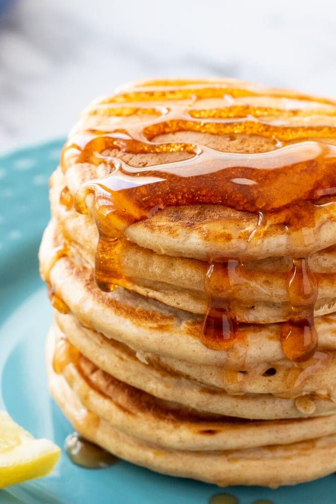Stack of Whole Wheat Pancakes drizzled with Maple Syrup.