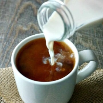 Homemade Coffee Creamer being poured into a white coffee mug.