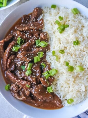 Instant Pot Mongolian Beef dished up in white serving platter with white rice