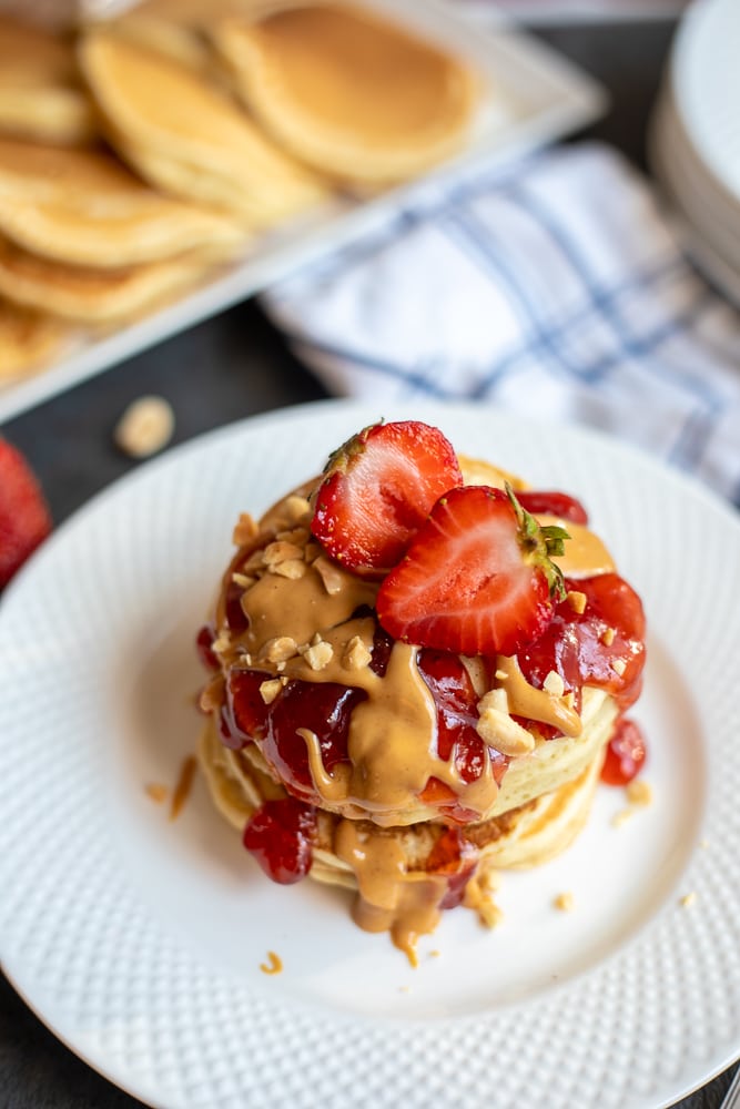 Peanut Butter Pancakes topped with strawberry sauce.