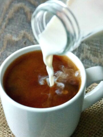 Homemade Coffee Creamer being poured into a white coffee mug