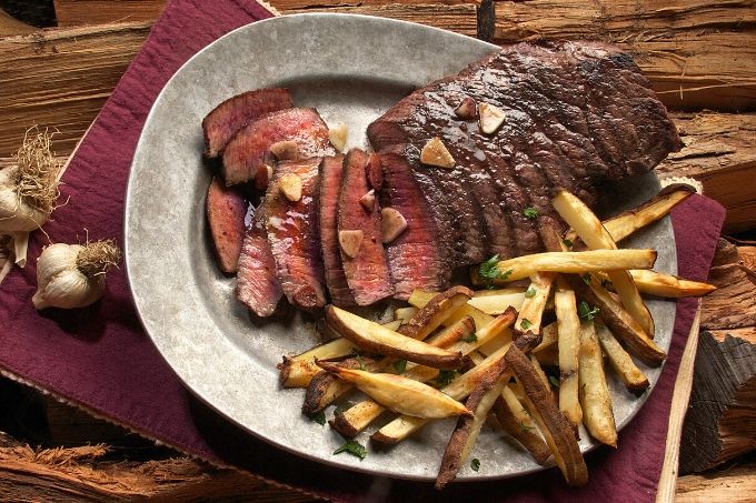 Steak and fries on silver plate