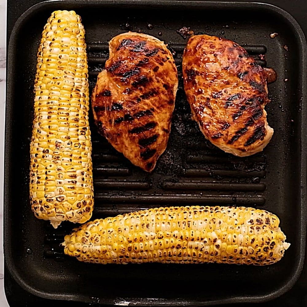 Chicken and corn on grill pan