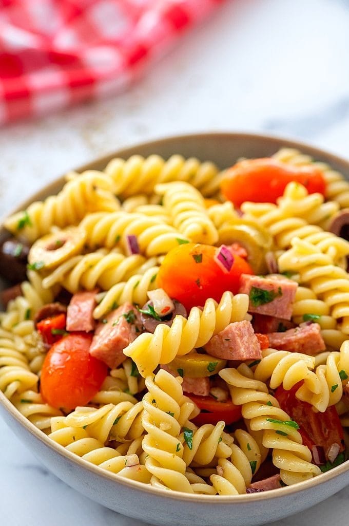 Close up of Antipasto Pasta Salad with tomatoes, onions, and pepperoni. 