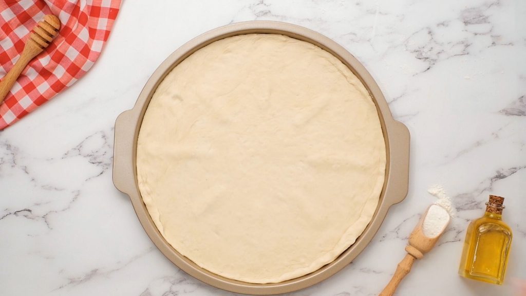 Pizza Crust on pizza pan sheet.