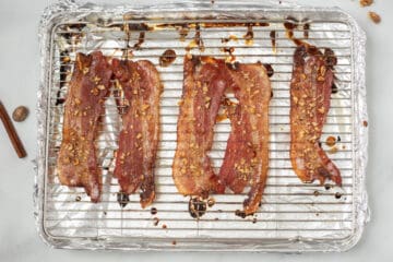 Candied Maple Bacon cooked and browned on baking sheet pan.