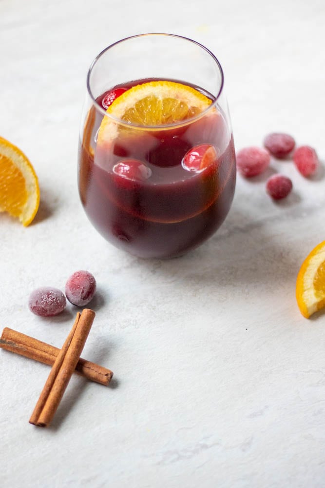Glass of mulled wine with oranges and cranberries