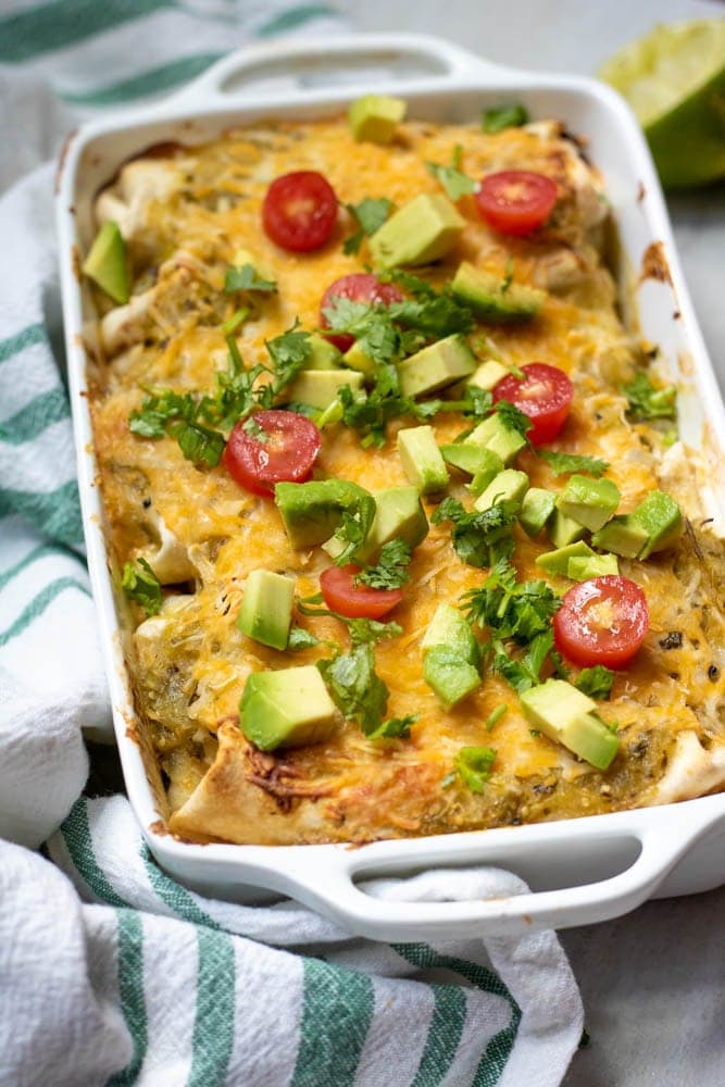 Chicken Enchiladas with green sauce baked and topped with fresh ingredients.