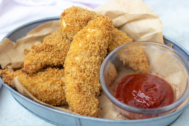 Homemade Chicken Strips in Basket with ketchup