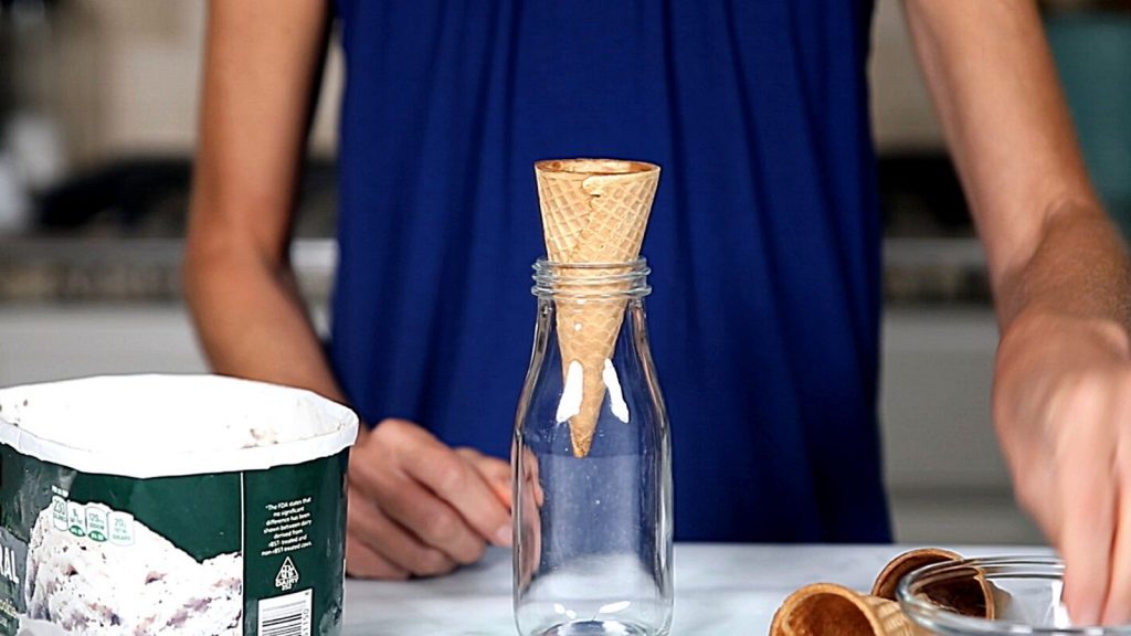 Ice Cream cone in glass jar next to ice cream