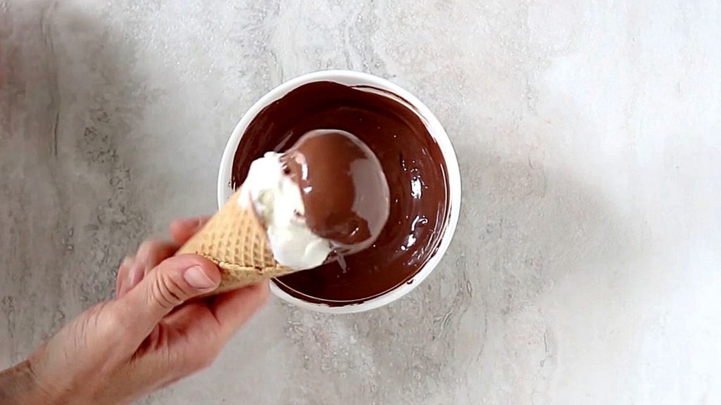 Ice Cream being dipped into melted chocolate