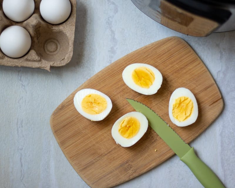 Perfectly cooked hard boiled eggs next to Instant Pot