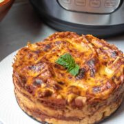 Layered Lasagna made in cheesecake pan next to instant pot