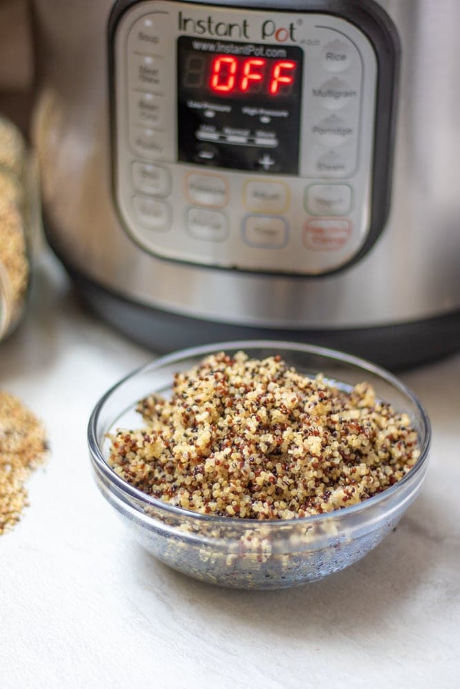 Perfectly cooked quinoa next to instant pot.