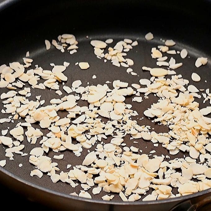 Almonds being toasted in dry skillet.