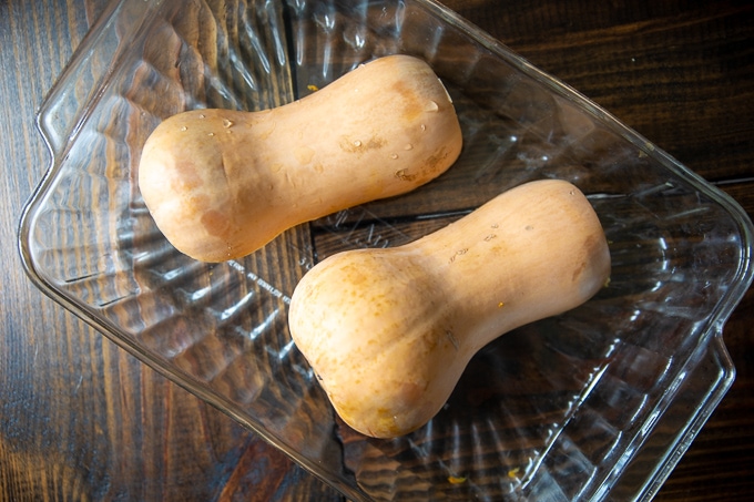 Butternut Squash Cut in half and placed in glass baking dish.