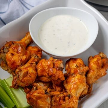 Platter of Instant Pot Wings next to ranch dressing