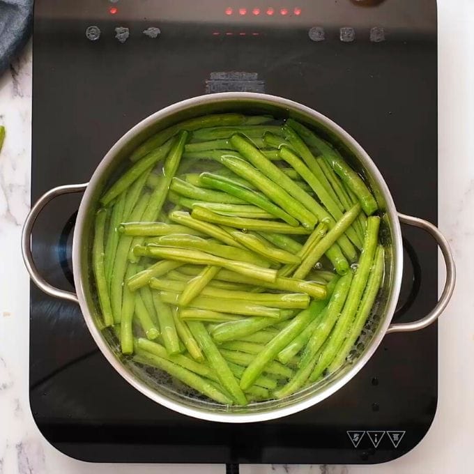 Green Beans in large stock pan of boiling water.