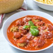 Bowl of chicken meatballs topped with basil