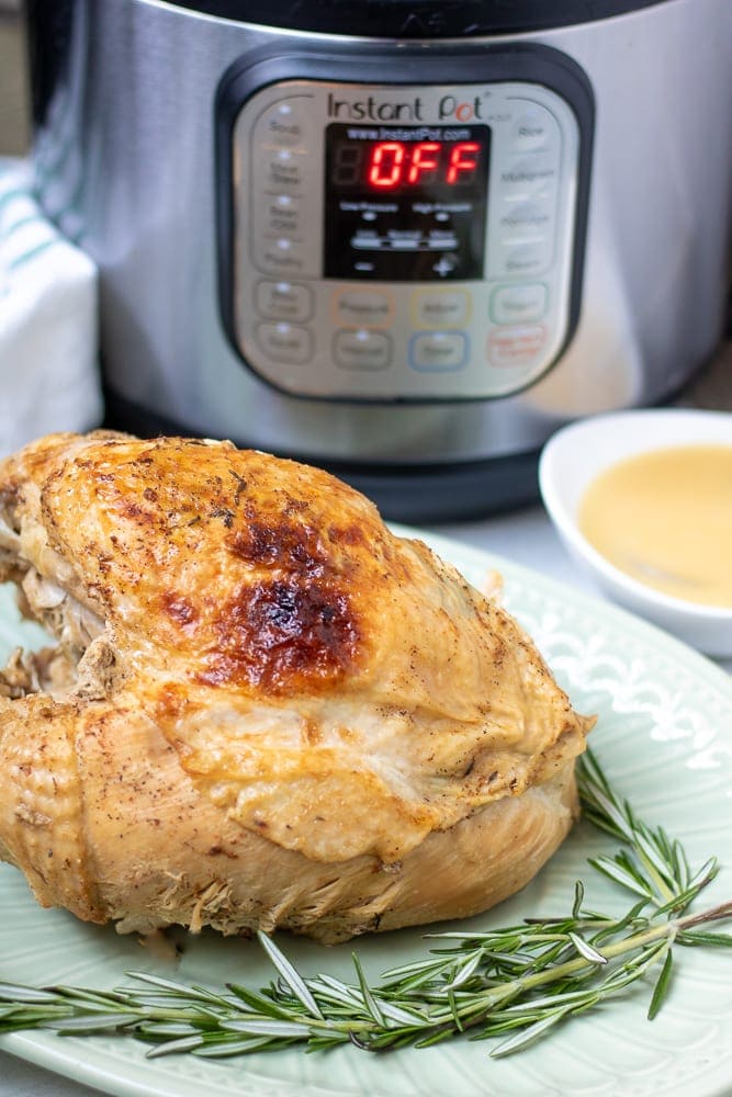 Turkey Breast on Platter next to Instant Pot.