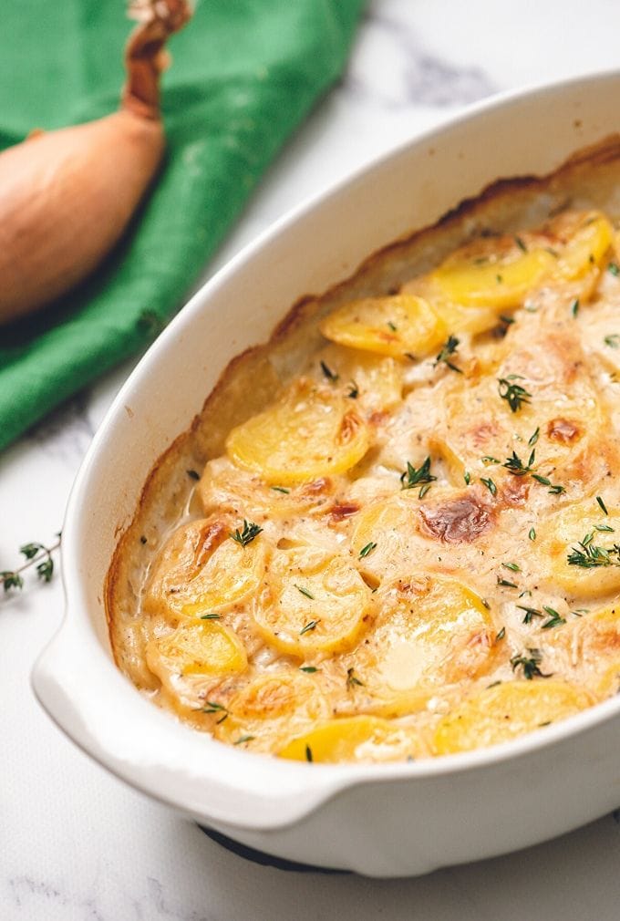 White Dish with baked scalloped potatoes.