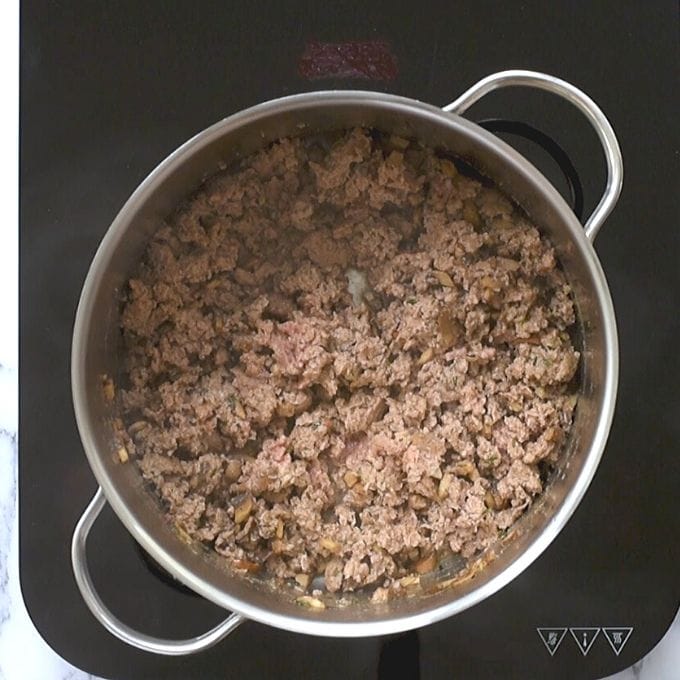 Ground beef in skillet with mushrooms