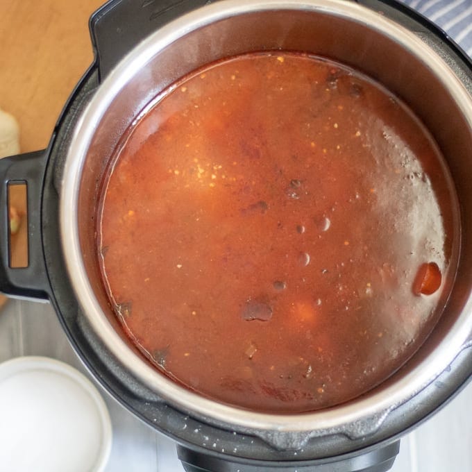 Ingredients inside pressure cooker for beef stew.
