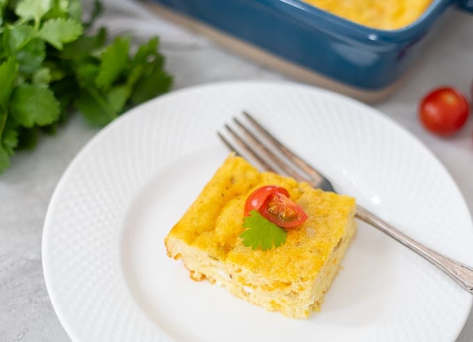 Egg Casserole with green chiles on white plate.