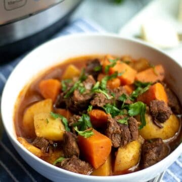 A bowl of Beef Stew next to an Instant Pot