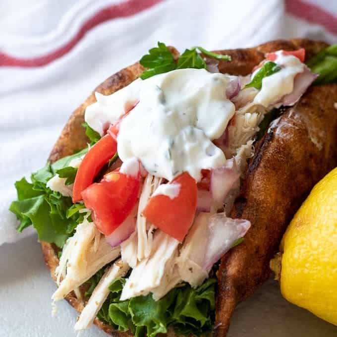 Pita bread stuffed with shredded chicken and diced tomatoes and Tzatziki