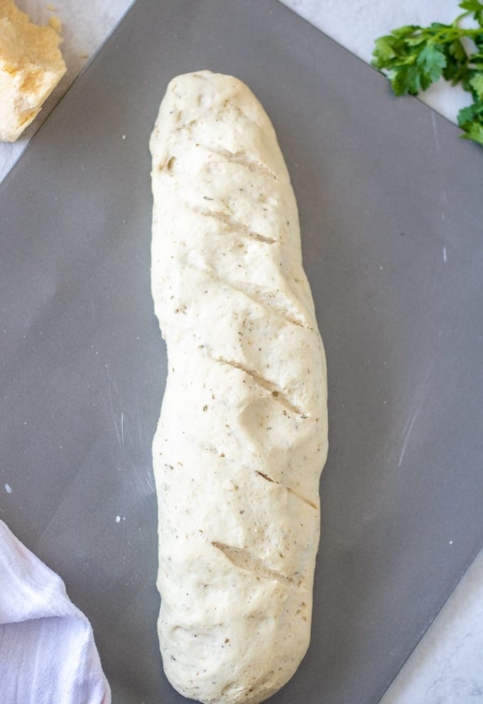 Italian Bread Dough Shaped in bread loaf on baking sheet.