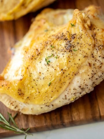 Baked Chicken Breast on Wooden Cutting board.