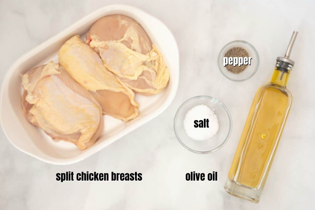 Split Chicken breast with salt and pepper and oil labeled on counter. 
