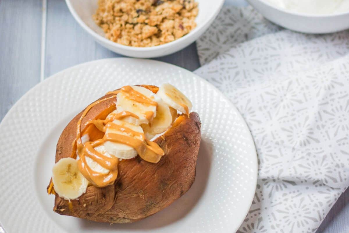 Baked Sweet Potato topped with slice banana and nut butter.