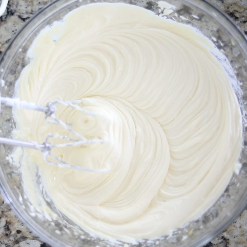 Creamy Cheesecake batter in clear mixing bowl.
