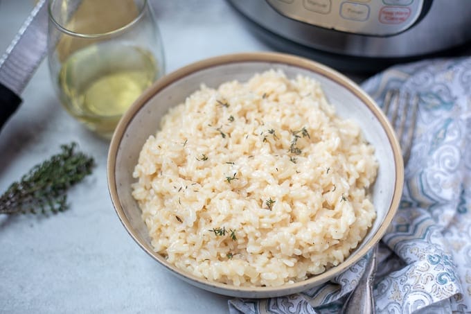 Risotto in a bowl in front of an instant pot